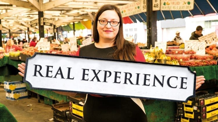 Kirsty Leicester holding street-sign