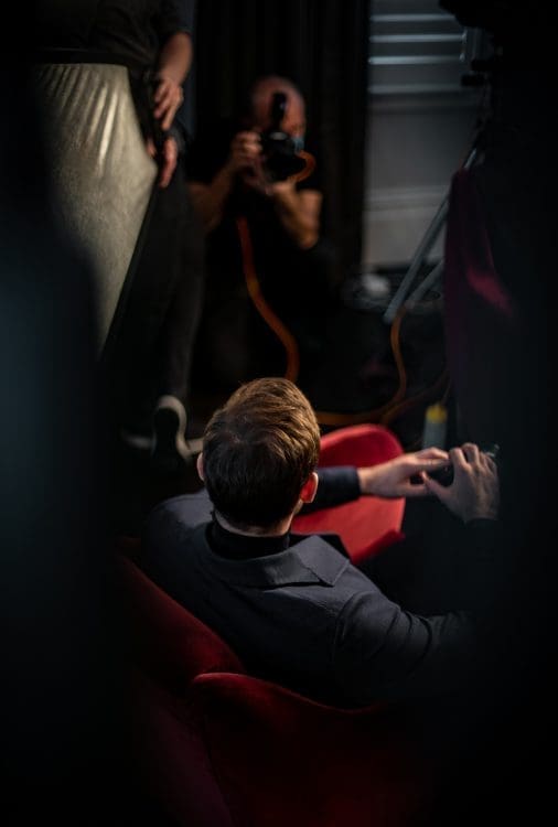 A man having his picture taken by a photographer