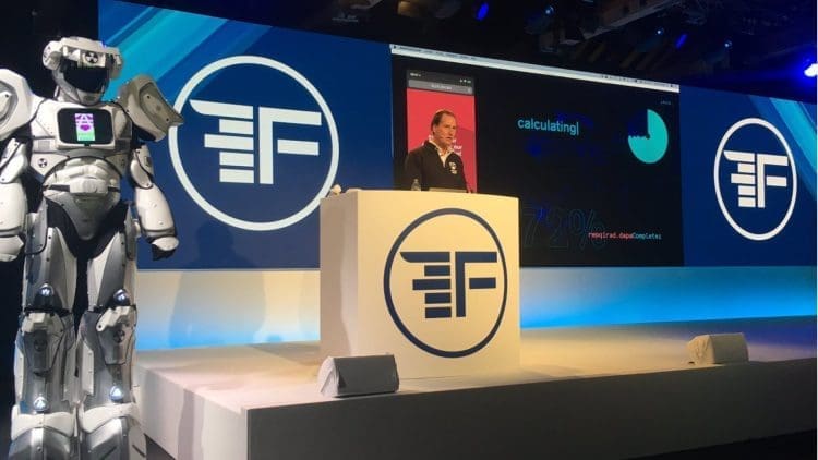 Advice robo robot standing next to a speaker on stage