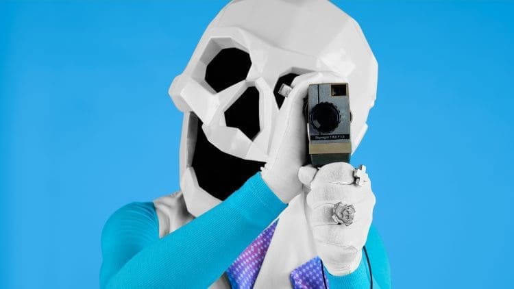 the dead happy mascot looking through an old camera