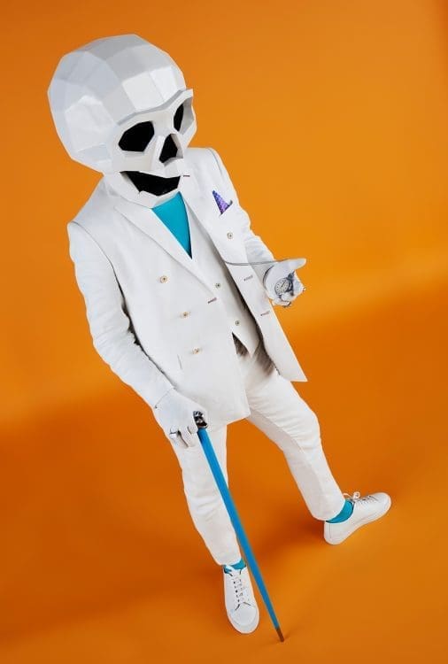 A skeleton in a white three-piece suit