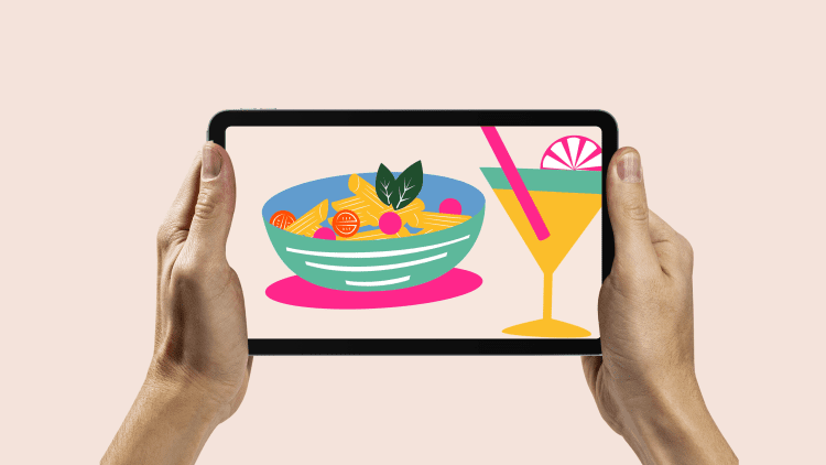 A bowl of pasta and a cocktail on a tablet