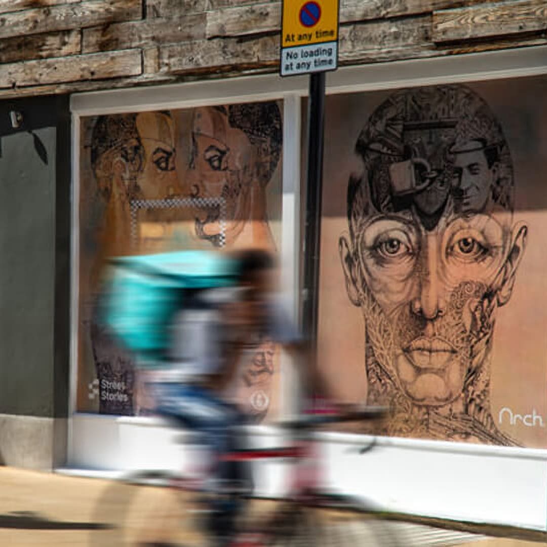 A shop window showing Street Stories artwork