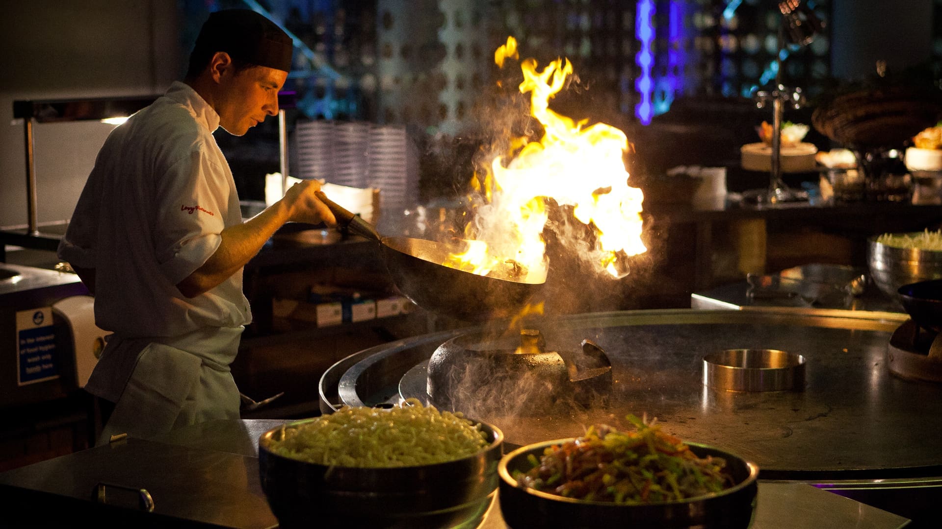 Chef using a wok to fry a stir fry